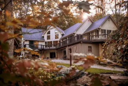 Lake House cabin in the spring, with fall colors on trees