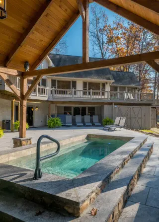 Plunge pool, with gazebo roof overhead and Lake house cabin in the background