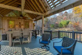 Lakeside gazebo, with seating and stained glass inlay, lake in the background.
