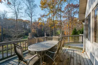 Outdoor dining table on the wraparound deck, stunning lake views in the background