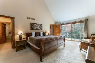 Spacious upstairs Master bedroom with king bed, sliding glass door leads to wraparound deck