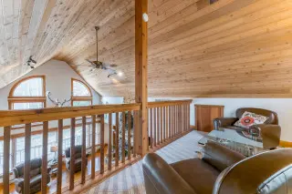 Lake House loft, with seating, overlooking the spacious living room 