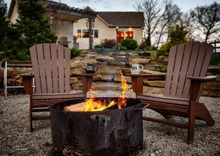 Cabin exterior, with campfire and 2 Adirondack chairs