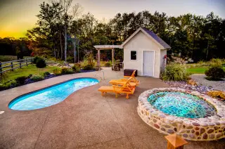Private pool and stone Cold Plunge with sun setting in the background
