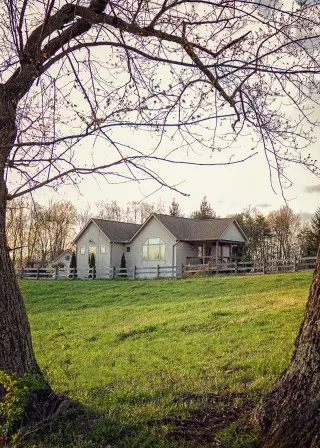 Cabin exterior, across a grassy field