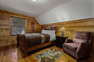 Upstairs room with queen bed and recliner chair