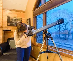 Woman looking through a telescope