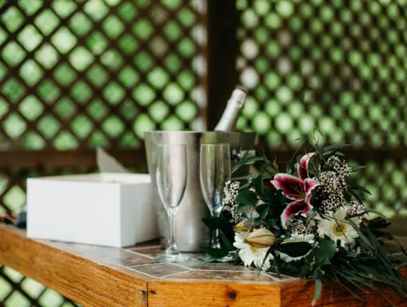 Cake, flowers and Champagne on a counter