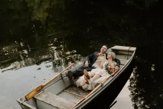 Bride and Groom laying back in a row boat