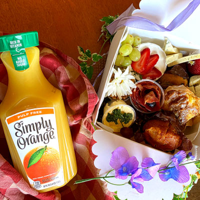 Photo of orange juice and pastries wrapped in a picnic box