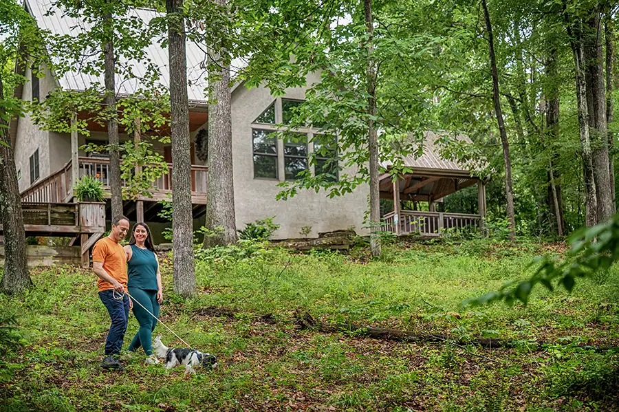 Large Hocking Hills cabin overlooking a private pond with fountain and colorful fall foliage