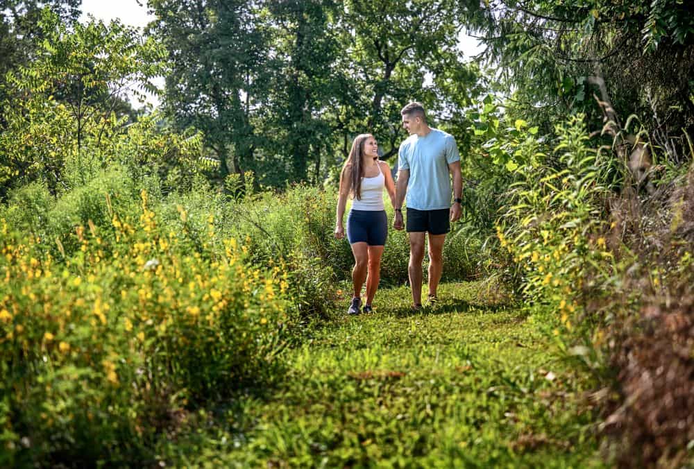 Couple walking through Cherry Ridge Retreat's native pollinator plots