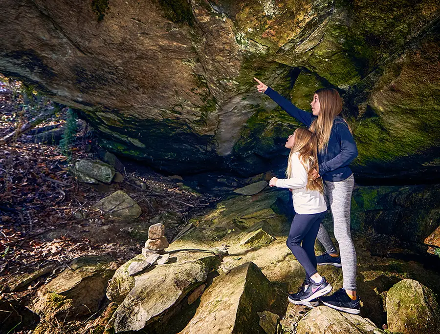 Sisters explore rock shelter Sisters exploring a natural rock shelter in the Hocking Hills