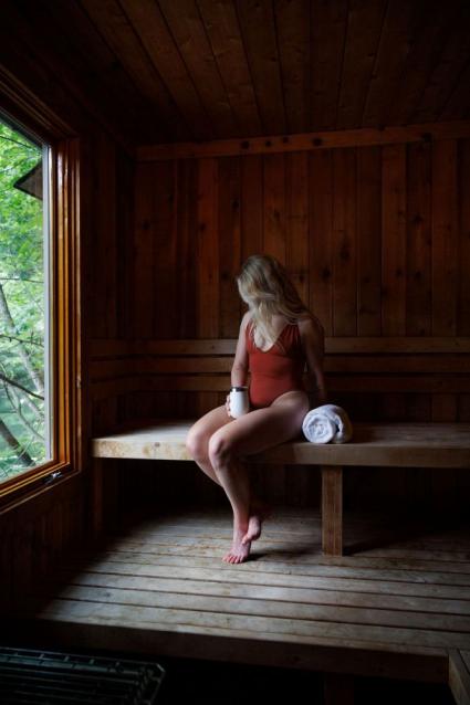 woman sits in the Boat House Sauna