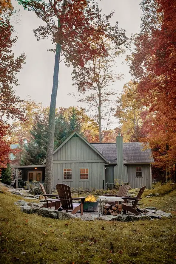 Campfire and seating, with Boat House cabin in the background