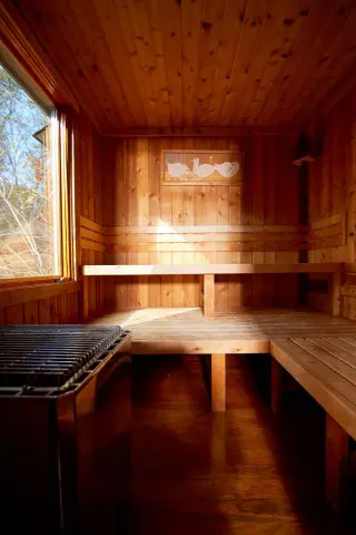 Wooden sauna with window overlooking the lake