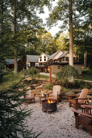 Fireplace with fire burning, stone stepway leading to the stunning cabin in the background