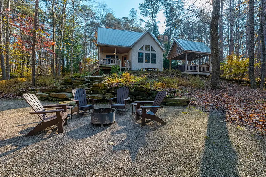 Secluded Hocking Hills cabin with outdoor fire pit, Adirondack chairs, and covered gazebo
