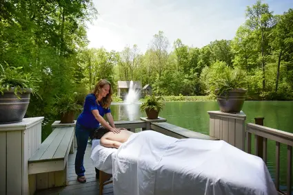 Outdoor massage on a private pondside deck at a Hocking Hills retreat 