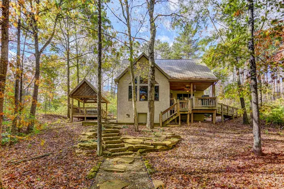 Cabin with stone walkway, woods surrounding