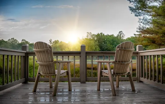 Two chairs sit overlooking the pond