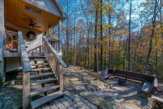 Cabin exterior and porch, fireplace and seating, forest surrounding
