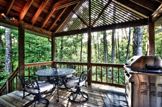 porch with metal table and gas grill, forest views surrounding