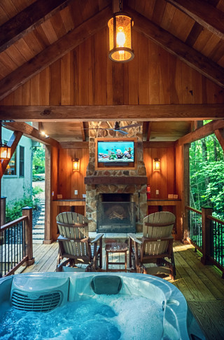 Bubbling hot tub, with fireplace and tv in background