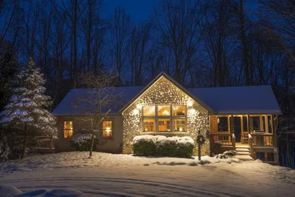 Snowy evening, with Ravine's Edge cabin glowing with warm light