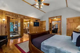room with king bed, overlooking the all glass shower with stained glass 
