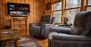 Living room with 2 recliners, coffee table, smart tv