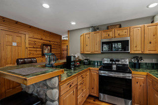 Kitchen, with wooden cupboards, oven, green counters